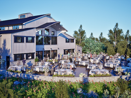 A large building with an outdoor terrace is set up for an event, featuring tables, chairs, and decorations, surrounded by trees.