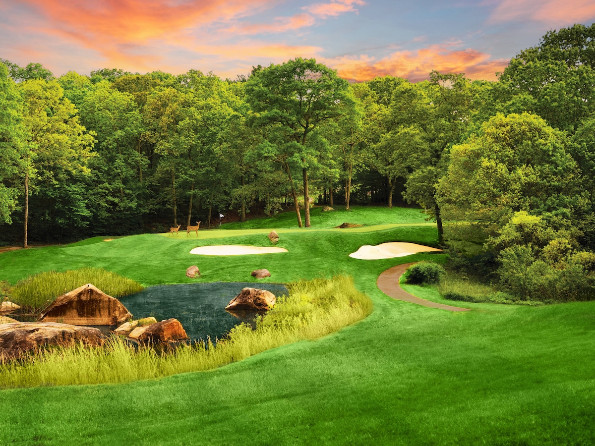 A scenic golf course with lush greenery, a sand trap, and a small pond surrounded by rocks under a colorful sky.