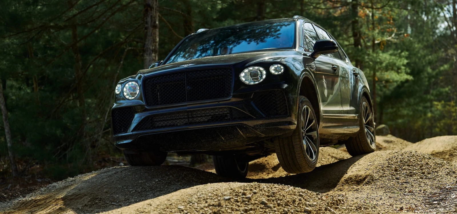 Bentley Bentayga driving over a rocky terrain at The Preserve Sporting Club.