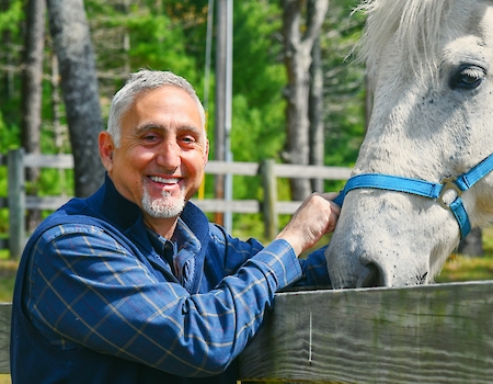 Paul Mihailides with a horse at The Preserve Sporting Club & Resort