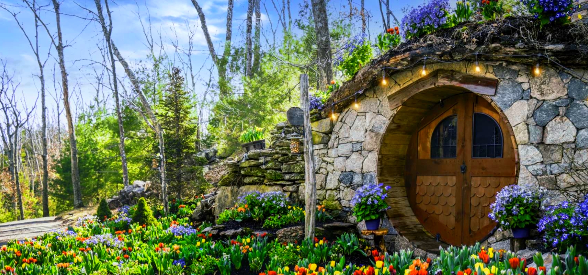 Hobbit House surrounded by vibrant flowers at The Preserve Sporting Club & Resort