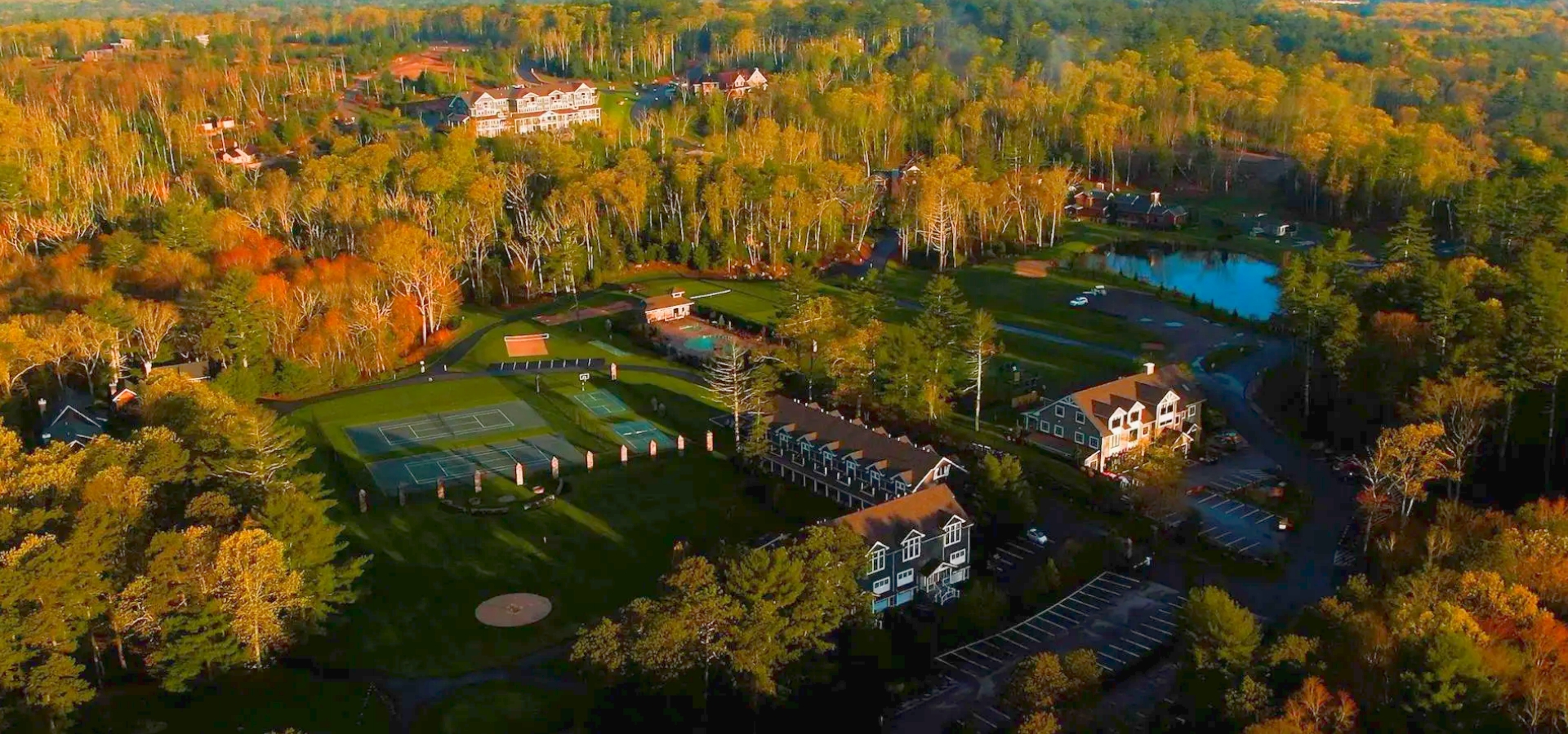 Aerial view of The Preserve Sporting Club & Residences surrounded by lush Rhode Island landscape.