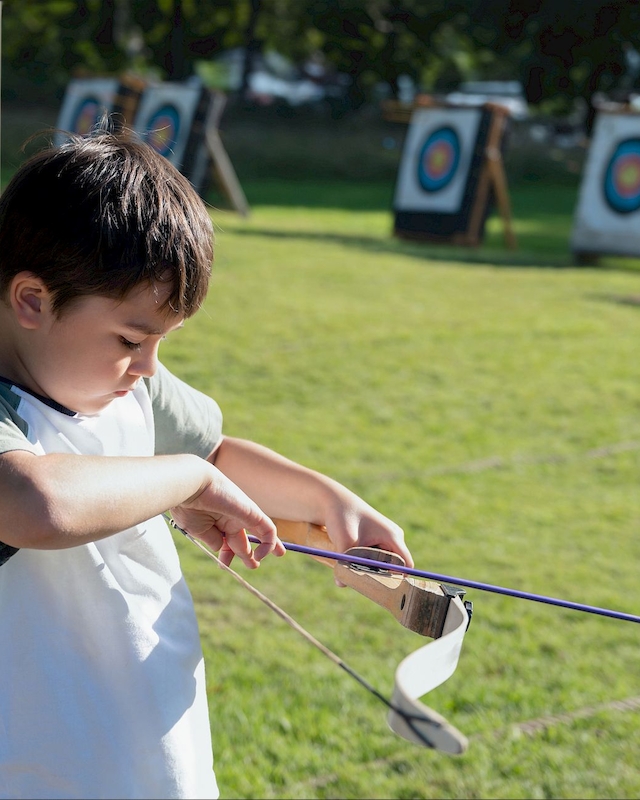 Young archer practices at Preserve Resort & Spa's Children's Club, promoting focus and fun in a safe outdoor setting.