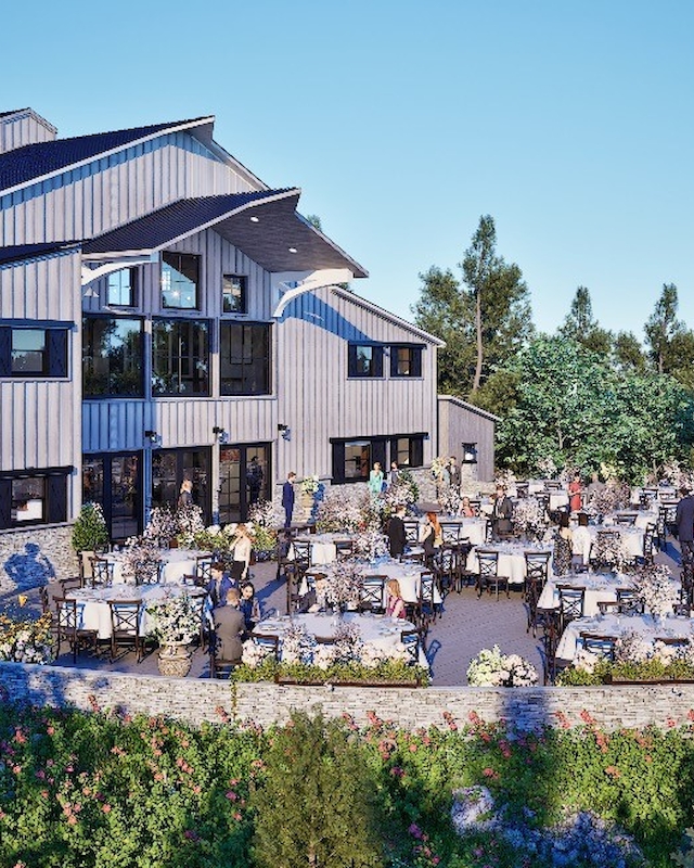 The image shows an outdoor event at a large building with tables, chairs, and guests, surrounded by trees and a scenic landscape.